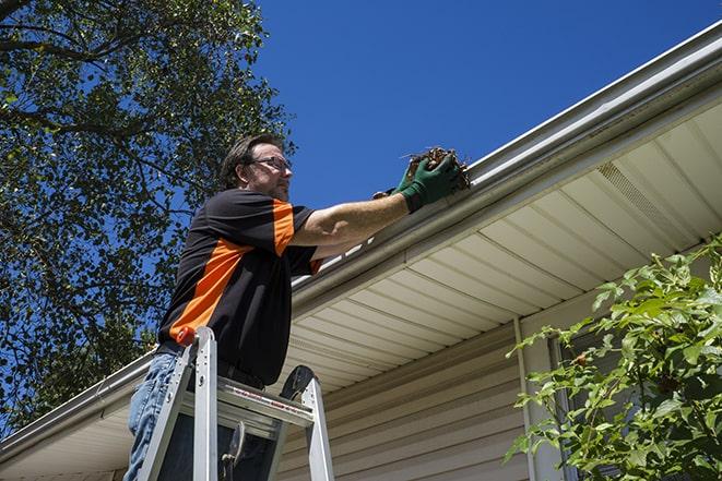 gutter being fixed by a maintenance person in Aliso Viejo CA